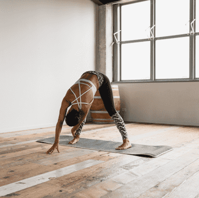 Woman doing yoga pose in yoga studio