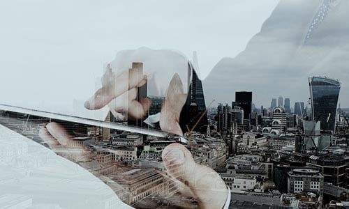 Person-using-tablet-overlay-with-city Person-using-tablet-overlay-with-city